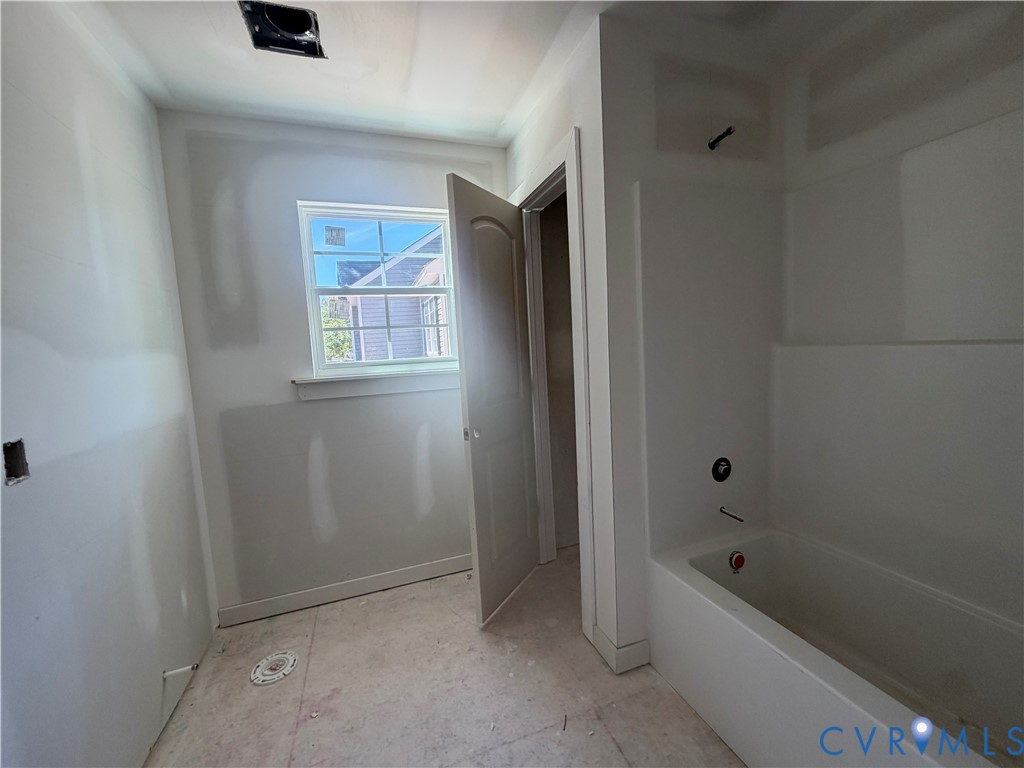 21305 Rutledge Avenue Petersburg, VA 23803 - Photo 5 of 14 a bathroom with a bathtub a window and a shower