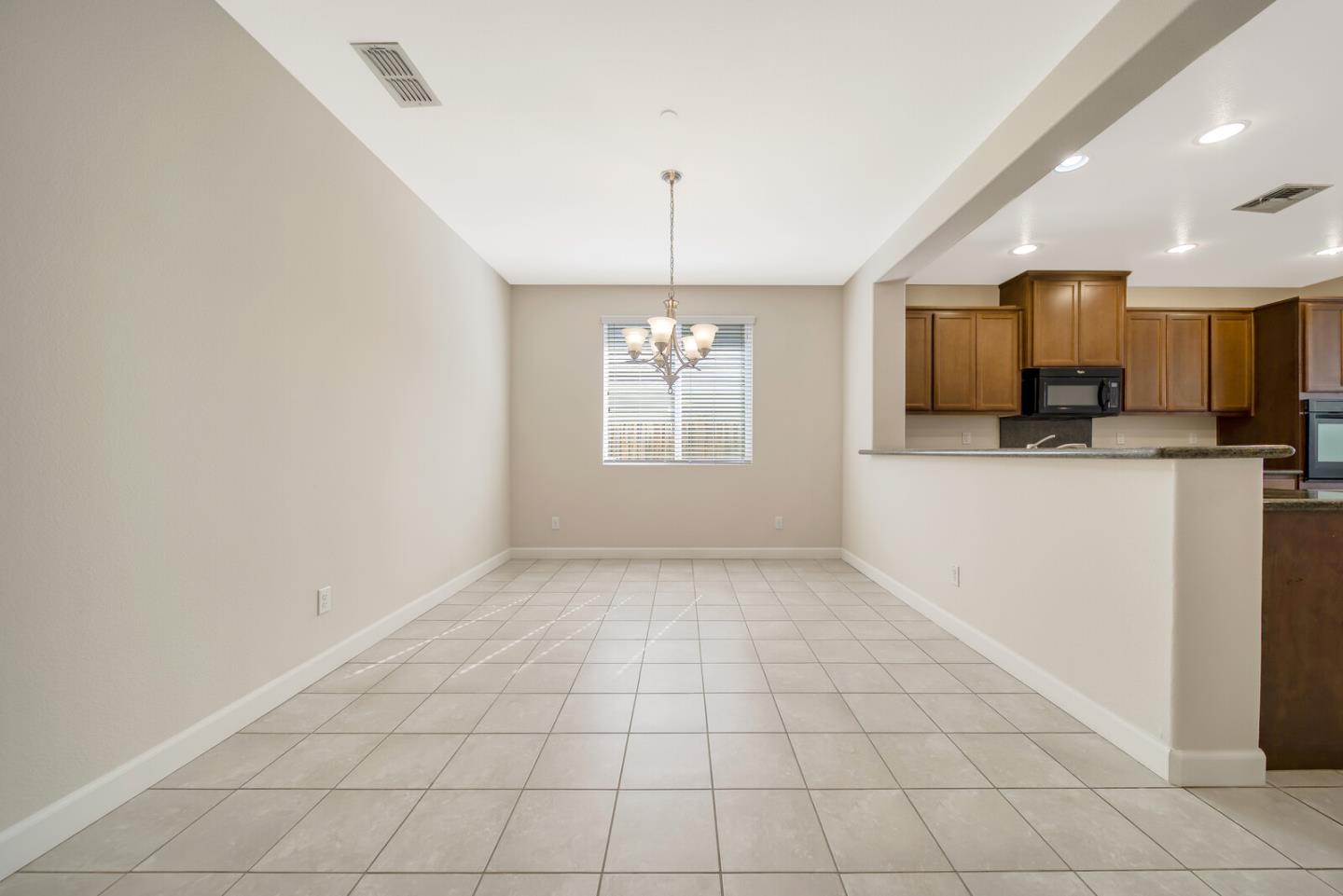 1479 Orgullo Lane Manteca, CA 95337 - Photo 11 of 39 a view of a kitchen with a sink and dishwasher with white cabinets