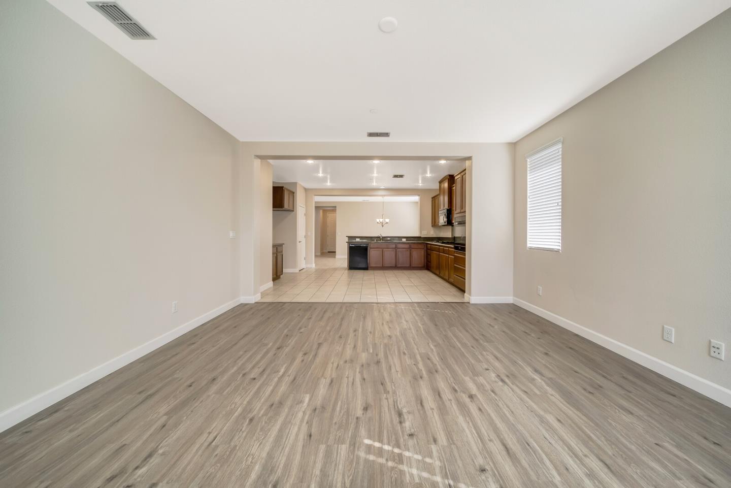 1479 Orgullo Lane Manteca, CA 95337 - Photo 18 of 39 wooden floor in an empty room with a window