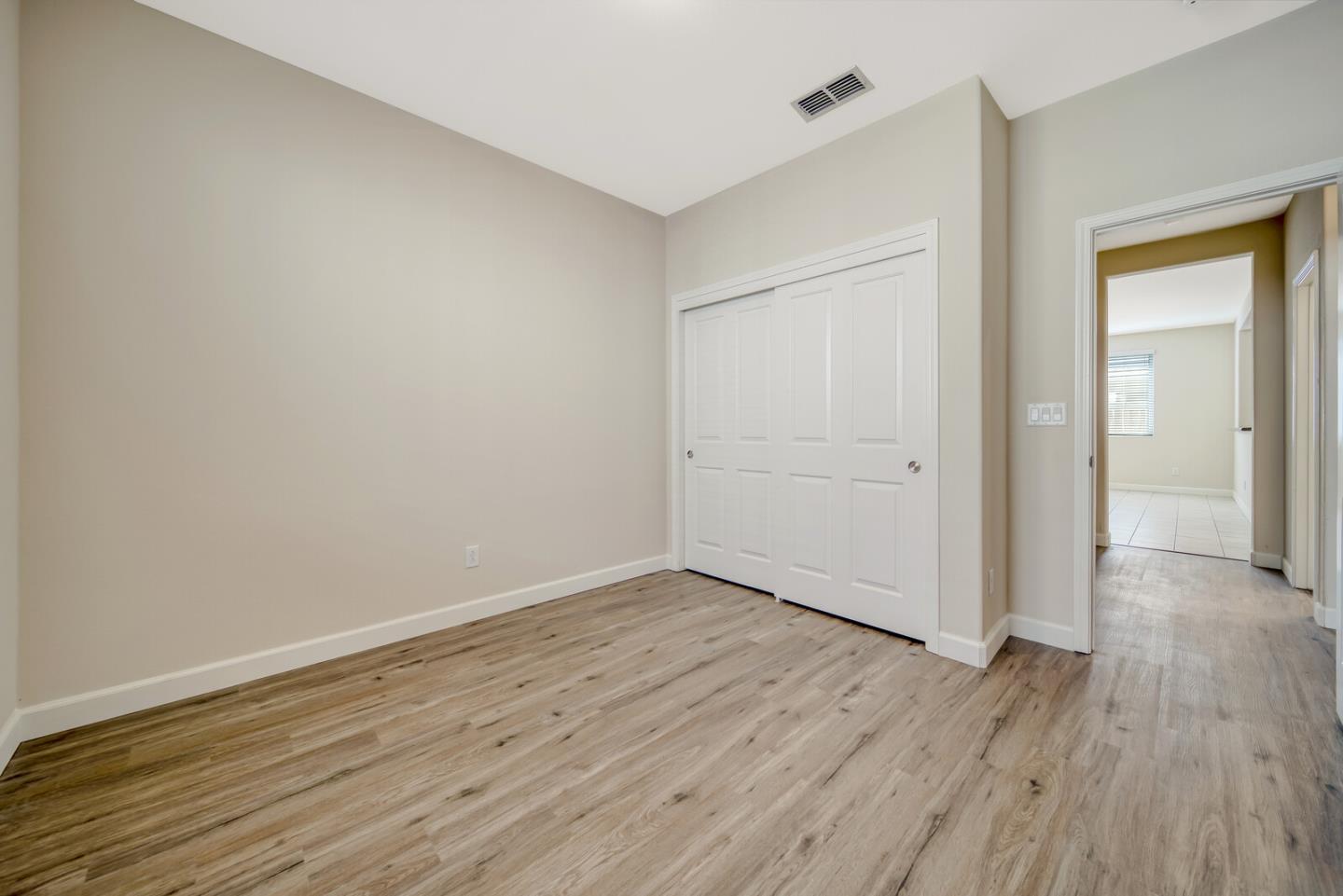 1479 Orgullo Lane Manteca, CA 95337 - Photo 22 of 39 a view of an empty room with wooden floor