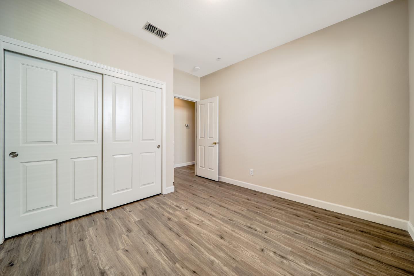 1479 Orgullo Lane Manteca, CA 95337 - Photo 23 of 39 a view of an empty room with wooden floor
