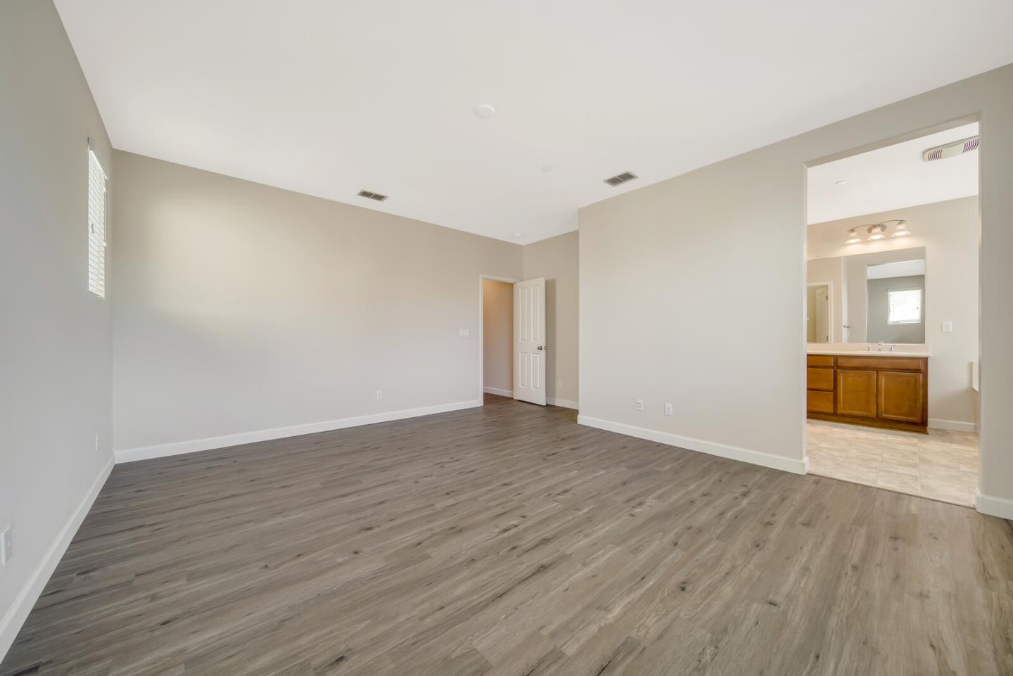 1479 Orgullo Lane Manteca, CA 95337 - Photo 29 of 39 a view of an empty room with wooden floor and a window