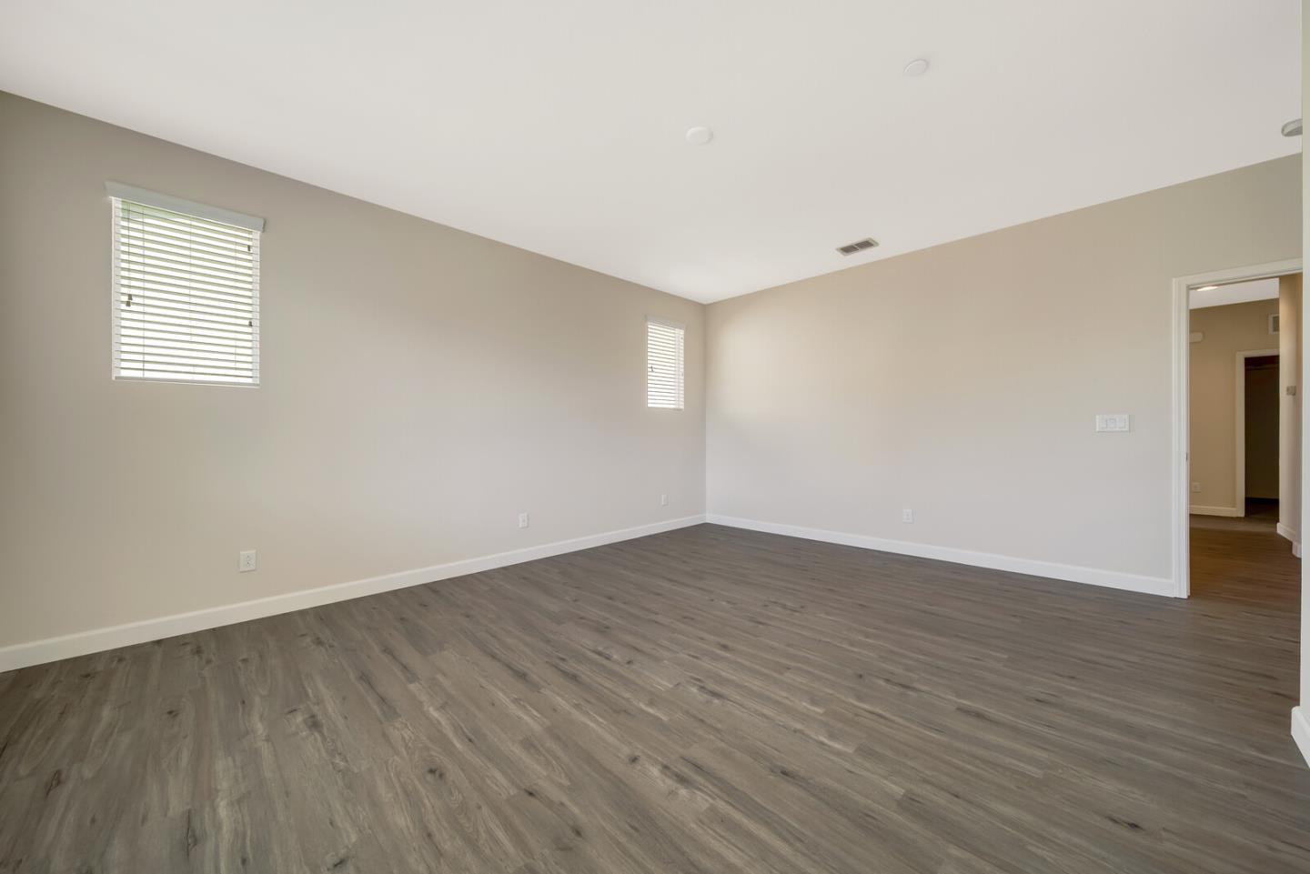1479 Orgullo Lane Manteca, CA 95337 - Photo 30 of 39 a view of an empty room with wooden floor and a window