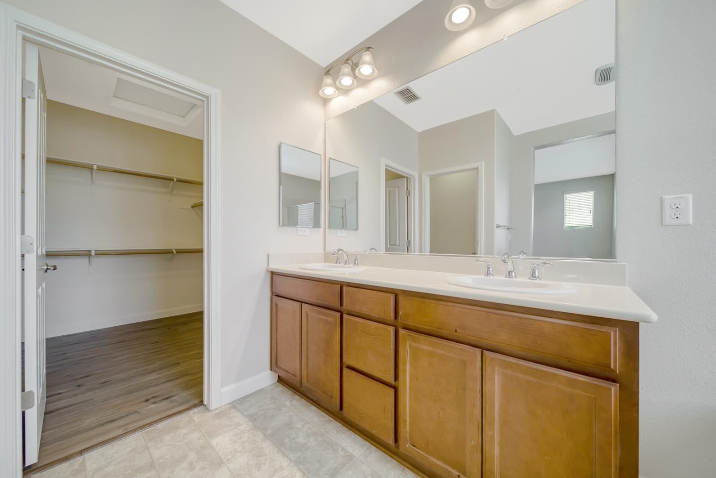 1479 Orgullo Lane Manteca, CA 95337 - Photo 32 of 39 a bathroom with a double vanity sink and a mirror