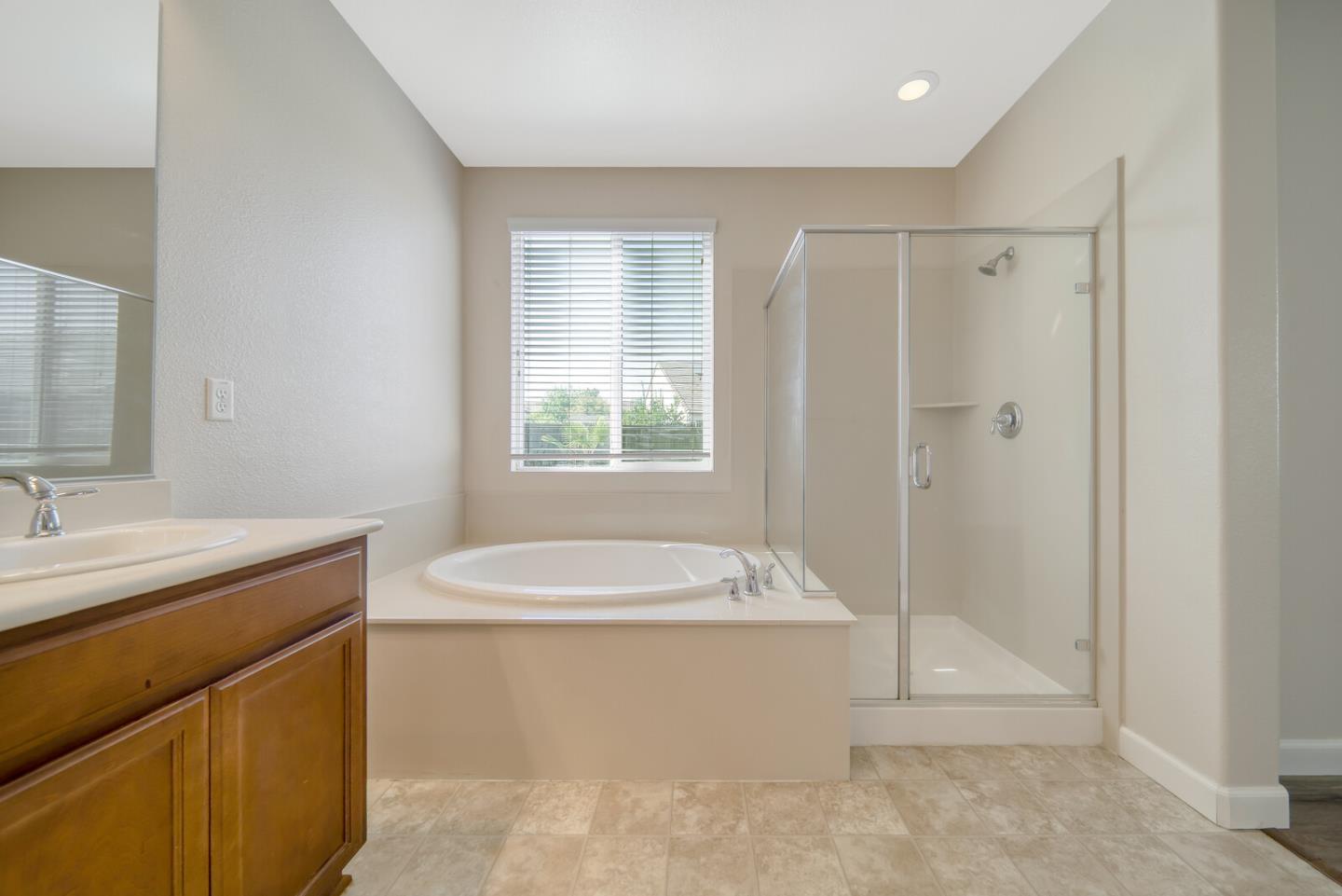 1479 Orgullo Lane Manteca, CA 95337 - Photo 34 of 39 a bathroom with a granite countertop sink a toilet and shower