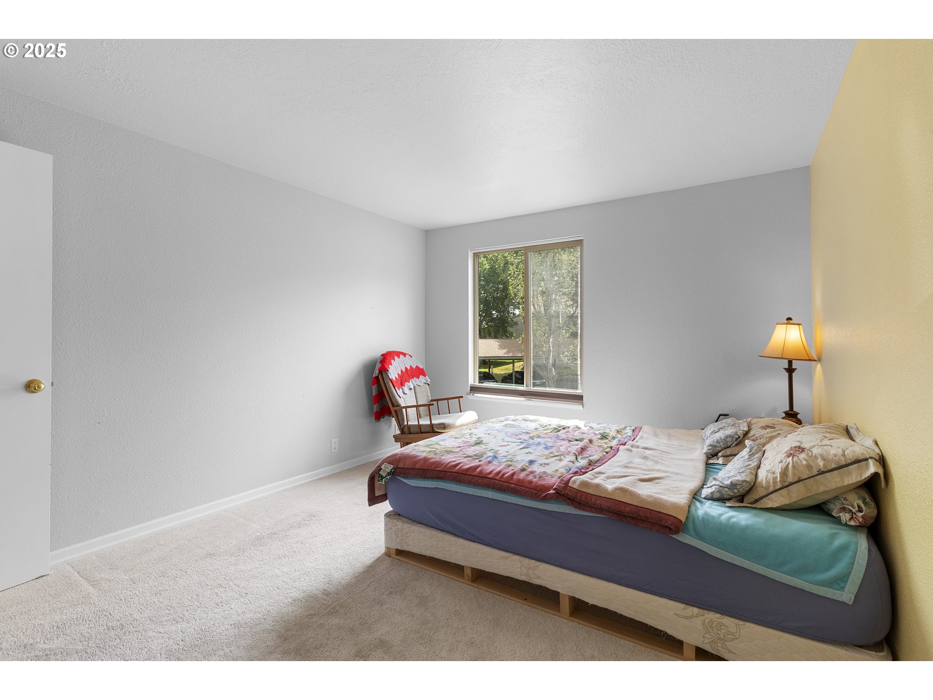 10137 Southwest Trapper Terrace Beaverton, OR 97008 - Photo 16 of 39 a bedroom with a bed and window