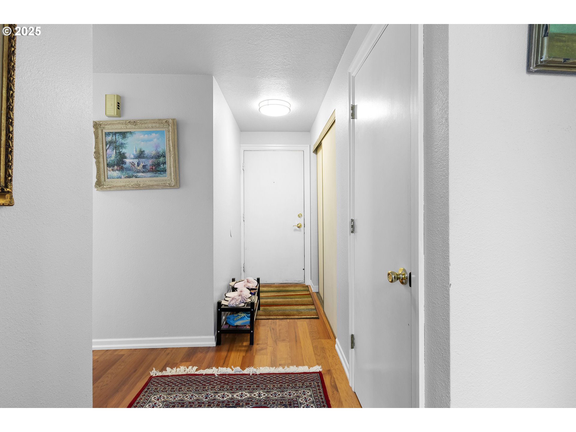 10137 Southwest Trapper Terrace Beaverton, OR 97008 - Photo 3 of 39 a view of a hallway with wooden floor