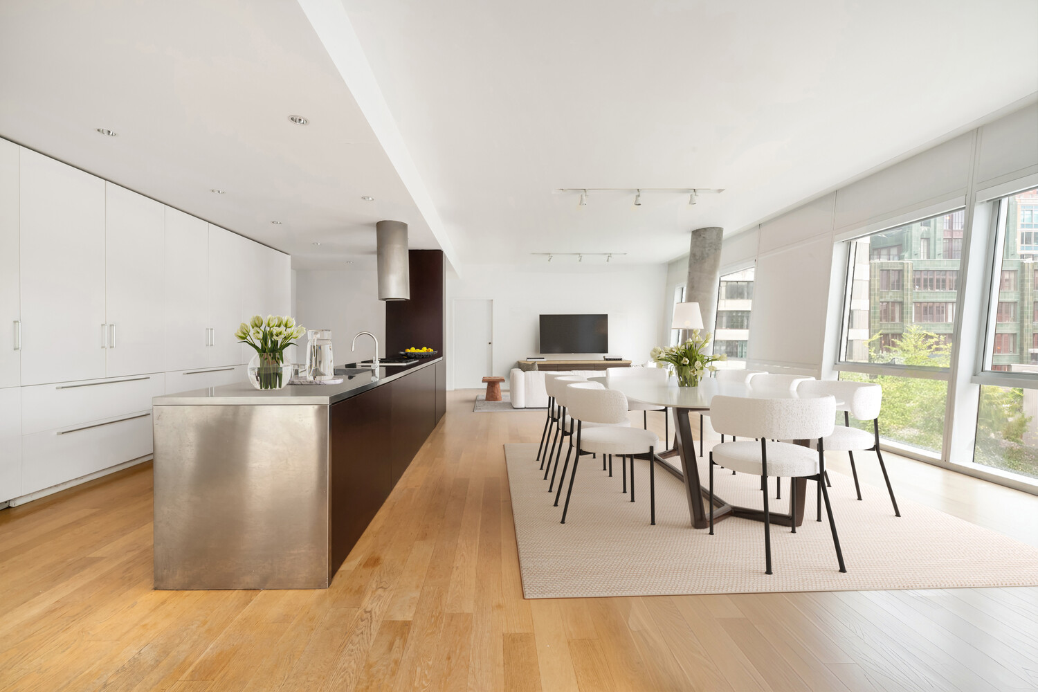 245 10th Avenue, Unit 5W Manhattan, NY 10001 - Photo 2 of 11 a view of a dining room with furniture and a potted plant