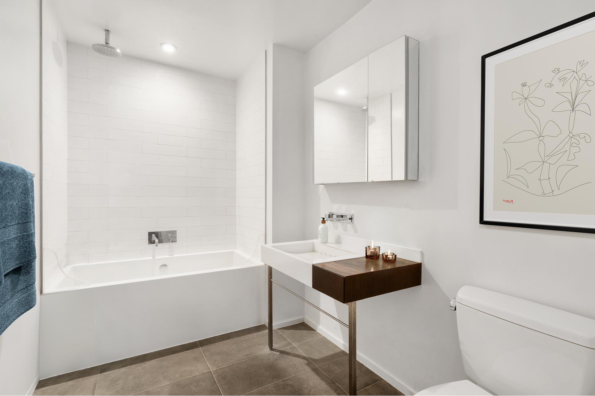 245 10th Avenue, Unit 5W Manhattan, NY 10001 - Photo 8 of 11 a bathroom with a sink a toilet and a bathtub
