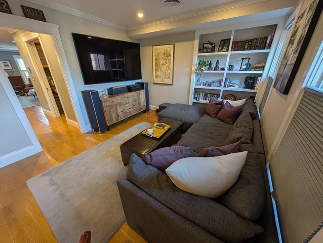 a living room with furniture window and a flat screen tv