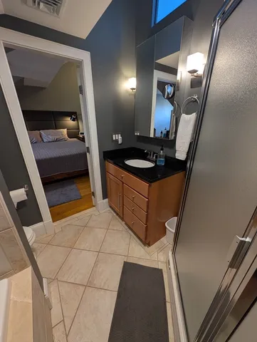 a bed sitting in a bedroom next to a window