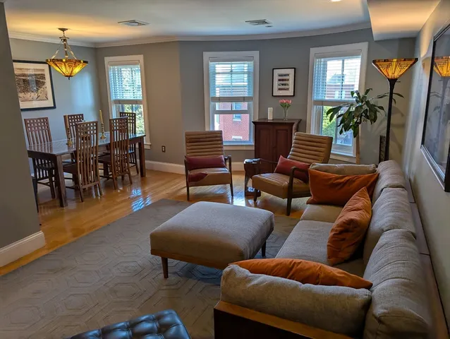 a view of a livingroom with furniture window and wooden floor