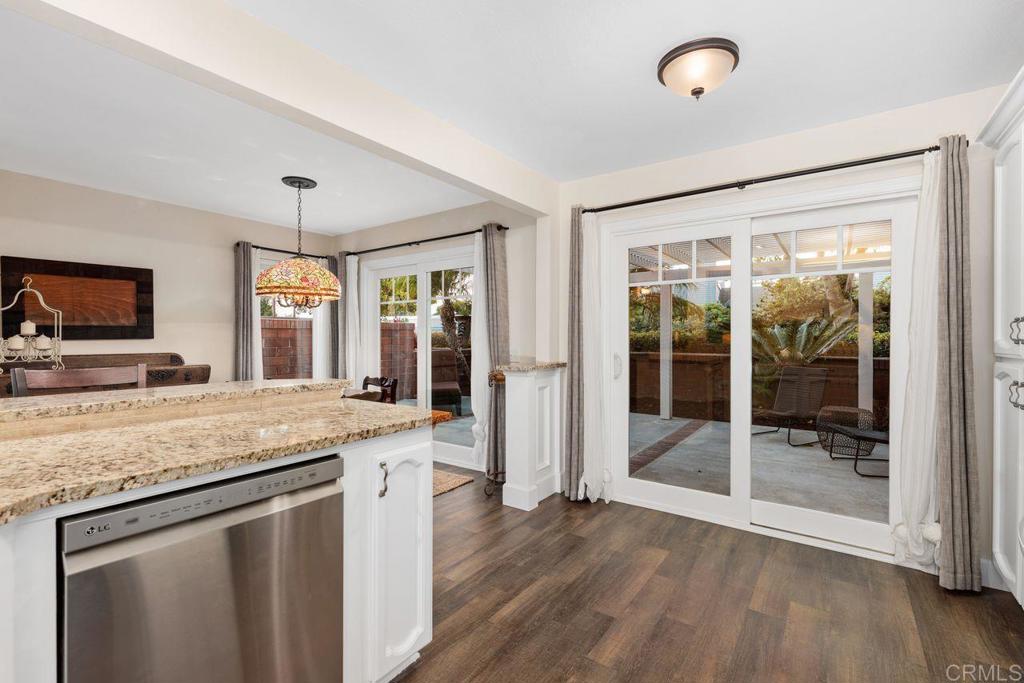 7325 Lantana Terrace Carlsbad, CA 92011 - Photo 12 of 36 a kitchen with a granite countertop sink and refrigerator