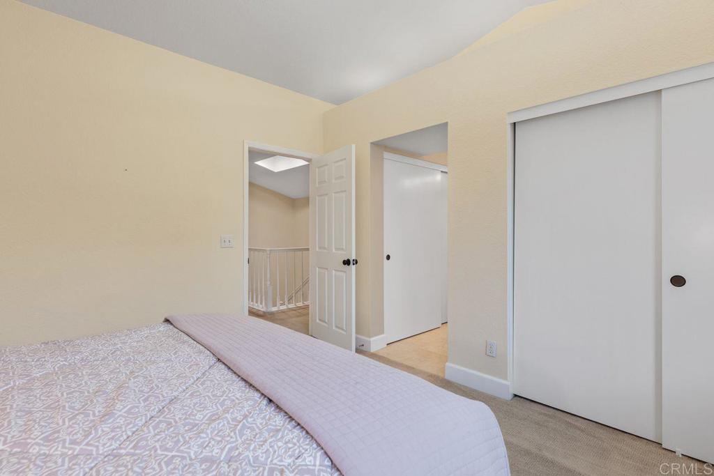 7325 Lantana Terrace Carlsbad, CA 92011 - Photo 22 of 36 a bedroom with a bed and a bathroom