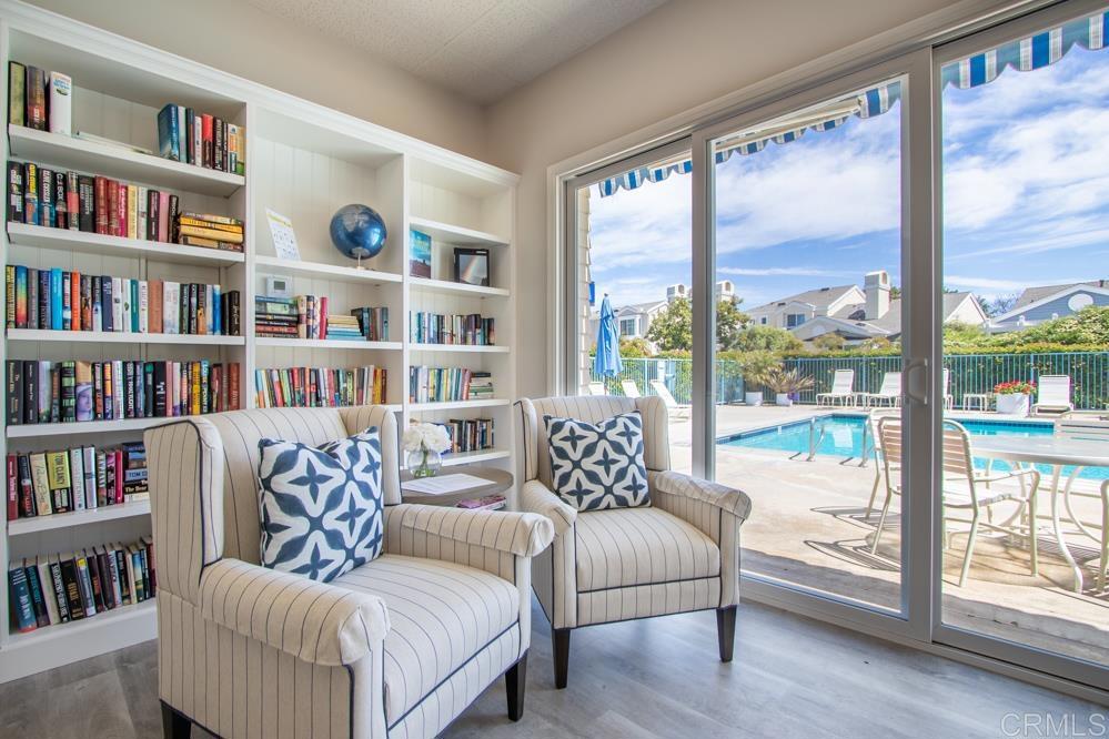 7325 Lantana Terrace Carlsbad, CA 92011 - Photo 34 of 36 a living room with a large bed and a book shelf