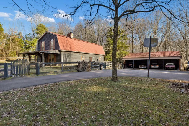 a house with lots of trees in front of it