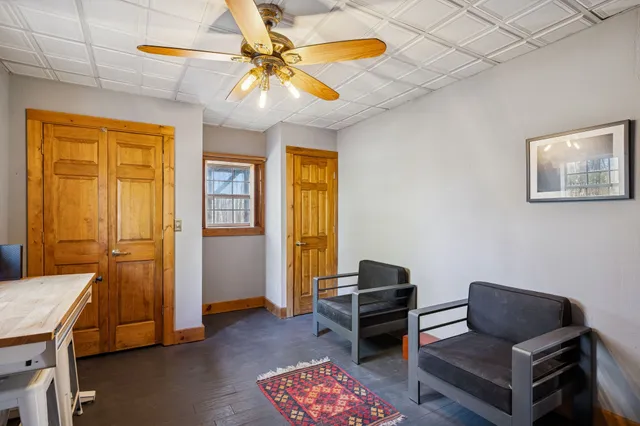 a living room with fireplace and a wooden floor