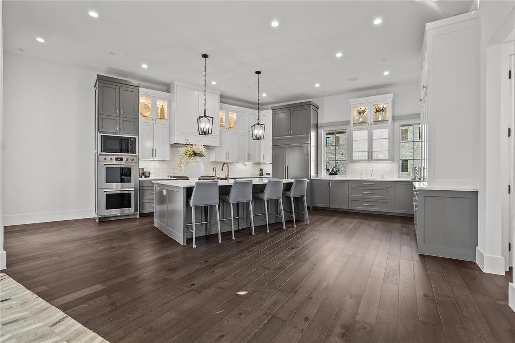 1 Piedra Court Roanoke, TX 76262 - Photo 11 of 40 a room with wooden floors and kitchen view