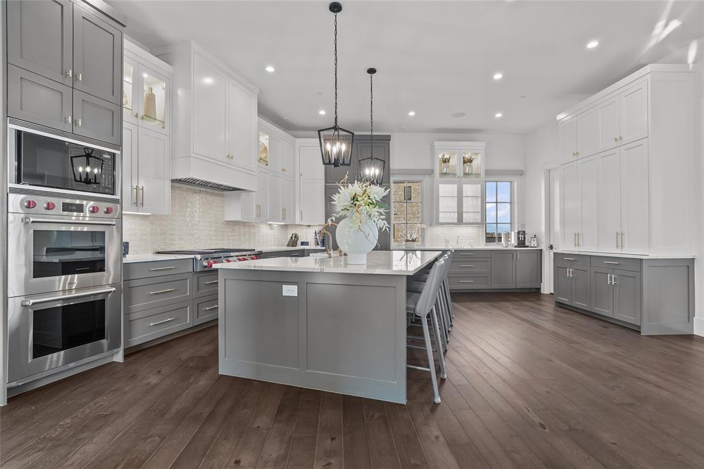 1 Piedra Court Roanoke, TX 76262 - Photo 13 of 40 a kitchen with kitchen island granite countertop a sink a counter space stainless steel appliances and cabinets