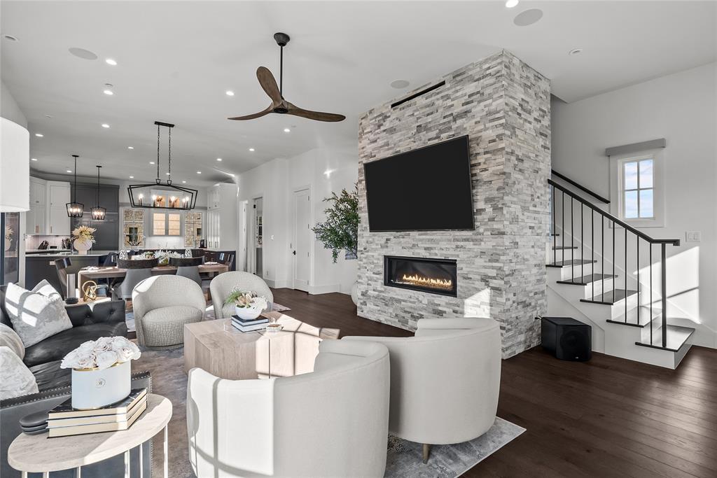 1 Piedra Court Roanoke, TX 76262 - Photo 18 of 40 a living room with furniture a flat screen tv and a fireplace