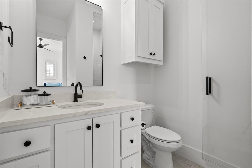 1 Piedra Court Roanoke, TX 76262 - Photo 24 of 40 a bathroom with a toilet sink and mirror
