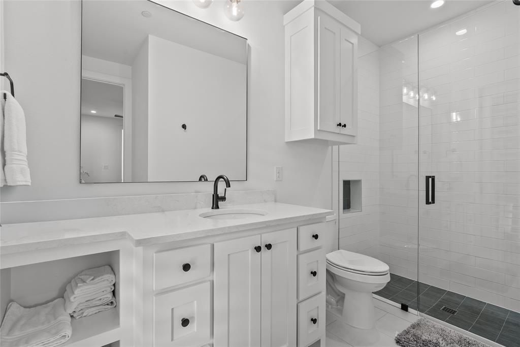 1 Piedra Court Roanoke, TX 76262 - Photo 8 of 40 a bathroom with a toilet sink and mirror