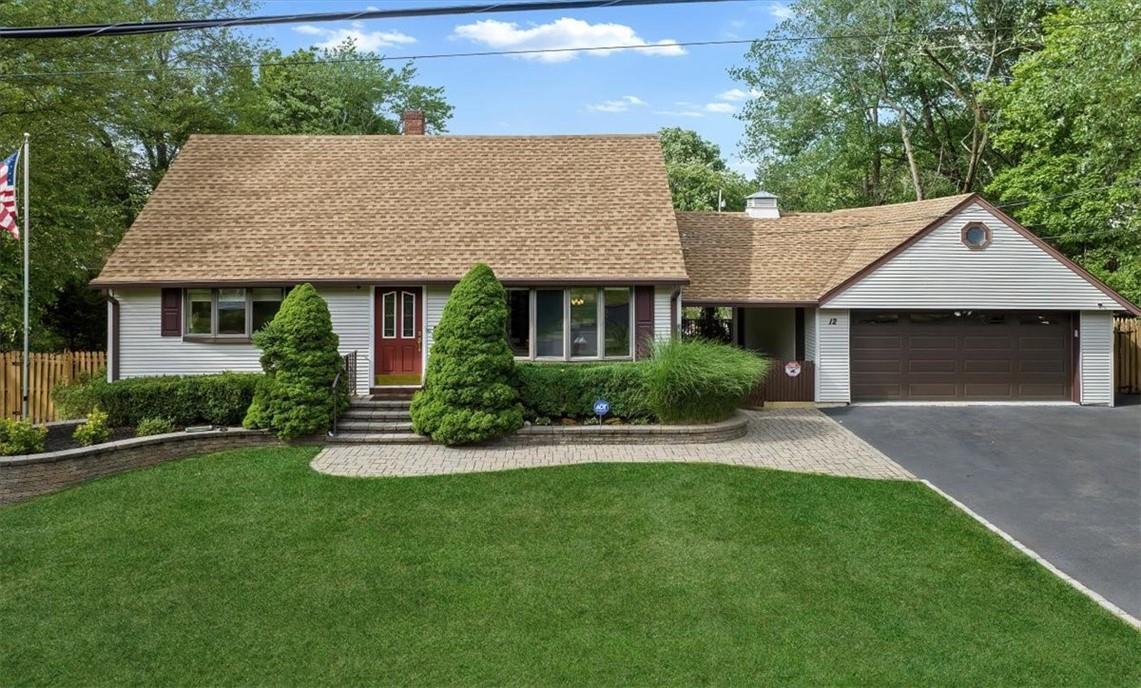 12 Sherman Drive Garnerville, NY 10923 - Photo 1 of 1 View of front of house with a front yard and a garage