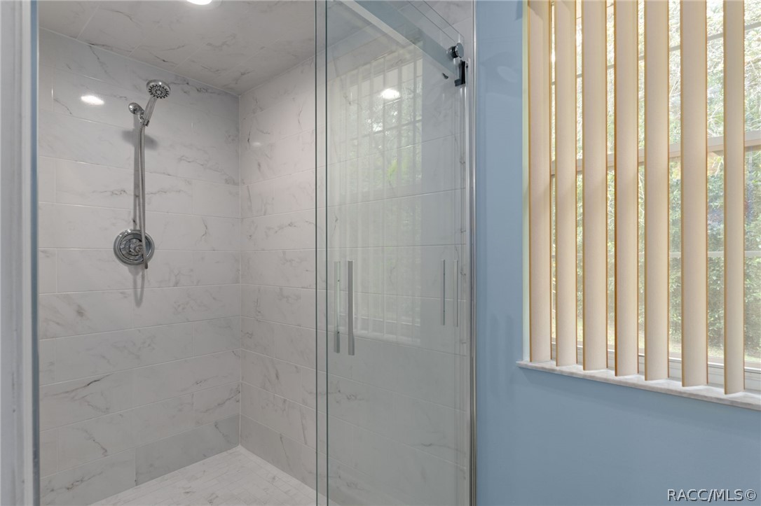 2460 West Pine Ridge Boulevard Beverly Hills, FL 34465 - Photo 21 of 47 a bathroom with a shower