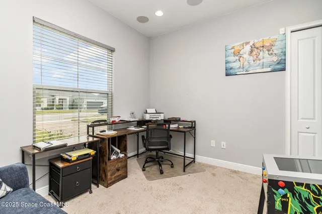 a living room with furniture a window and a potted plant