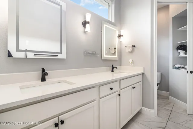 a bathroom with a sink a vanity and a mirror