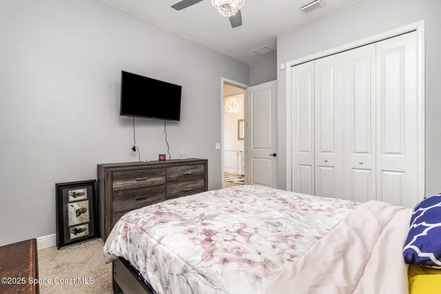 a bedroom with a bed and a tv