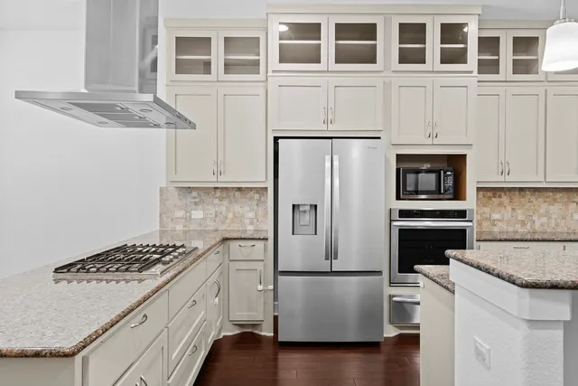 a kitchen with cabinets and steel stainless steel appliances