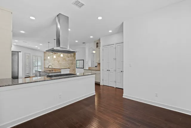 a large kitchen with a sink and a stove top oven