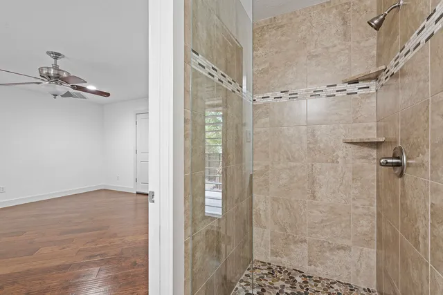 a bathroom with a glass shower door