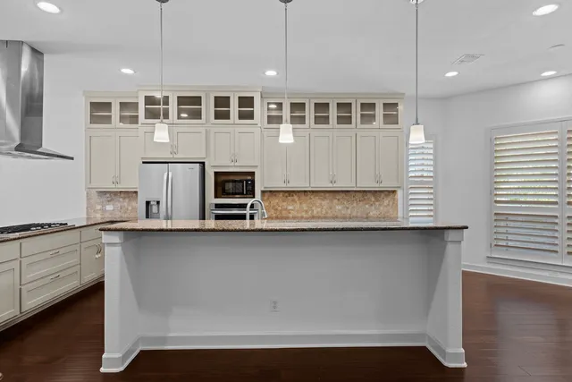 a kitchen with stainless steel appliances granite countertop a stove and a sink