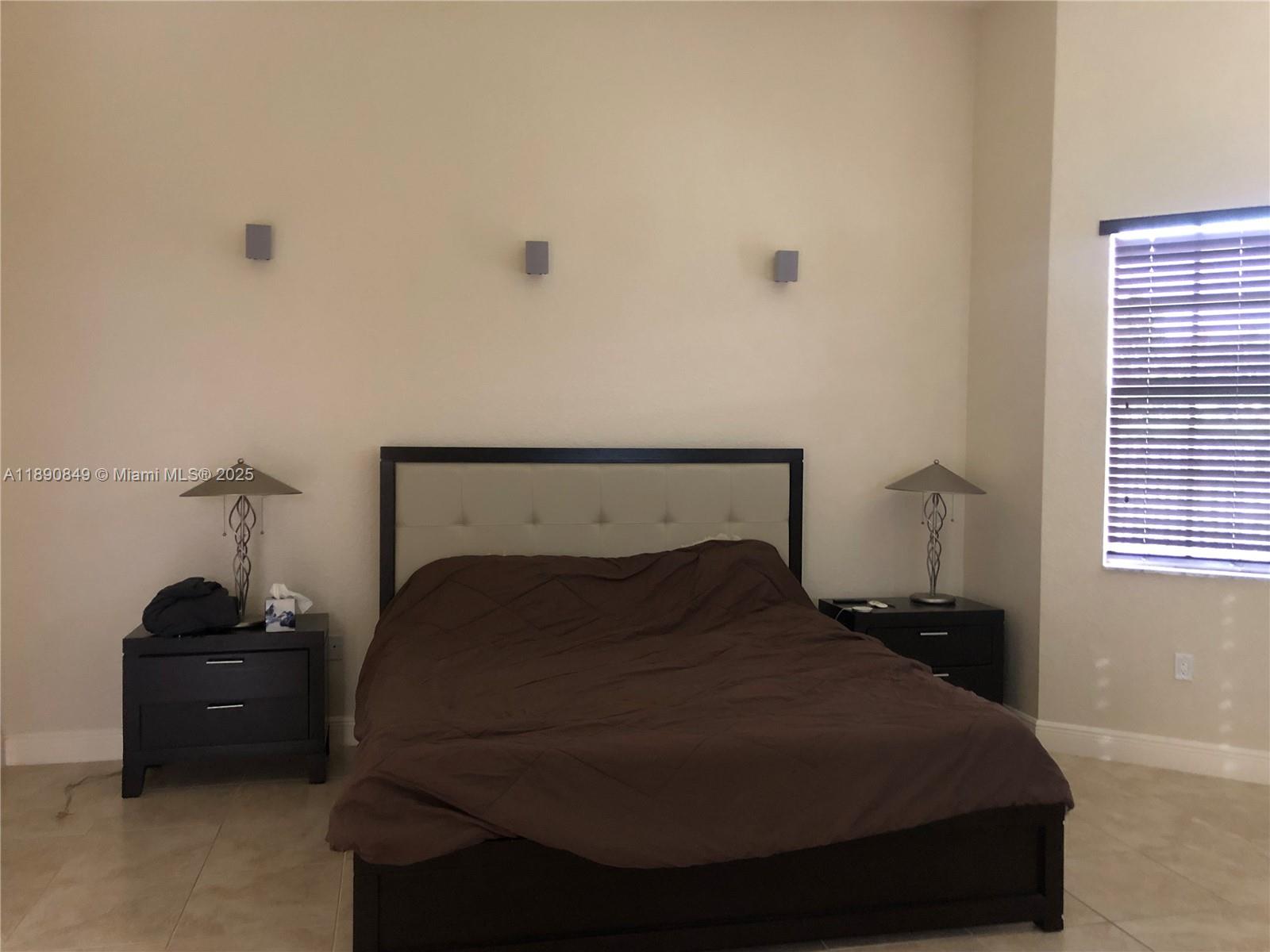 18721 Southwest 291st Terrace Homestead, FL 33030 - Photo 11 of 15 a bedroom with a bed and a window