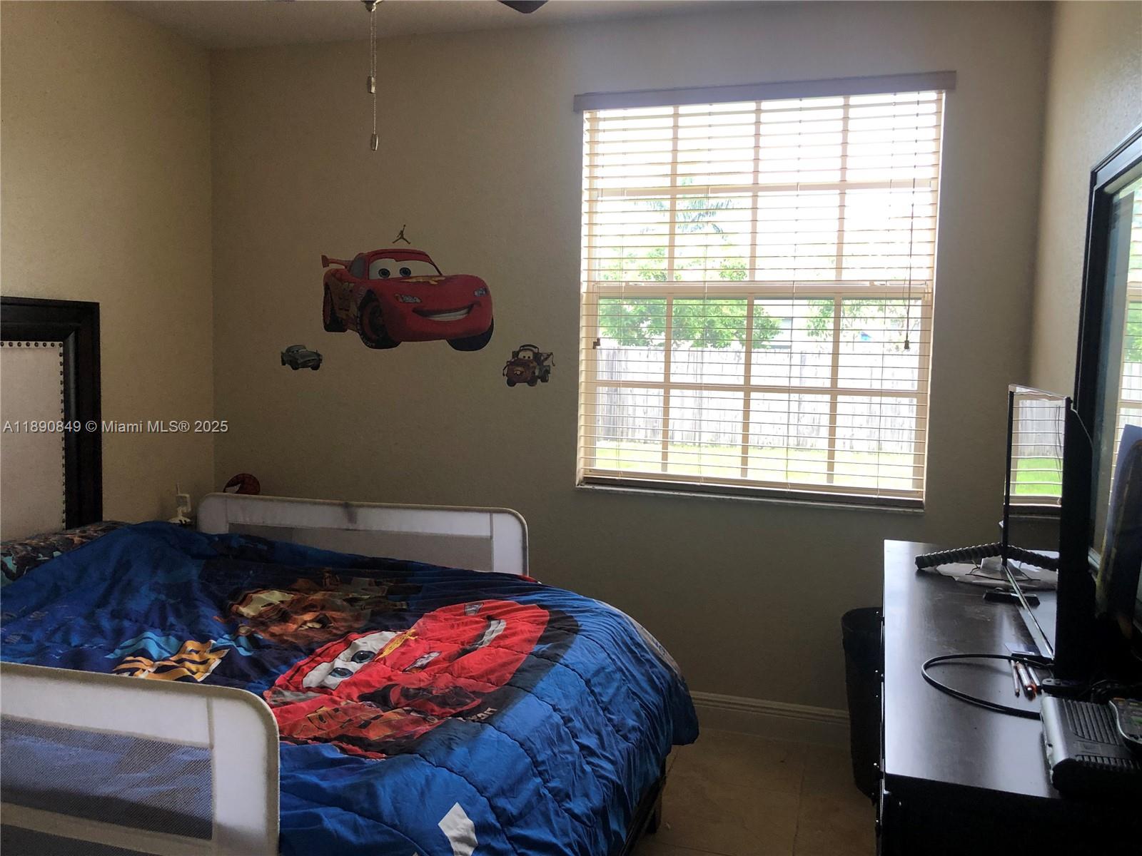 18721 Southwest 291st Terrace Homestead, FL 33030 - Photo 12 of 15 a bedroom with a bed and wooden floor