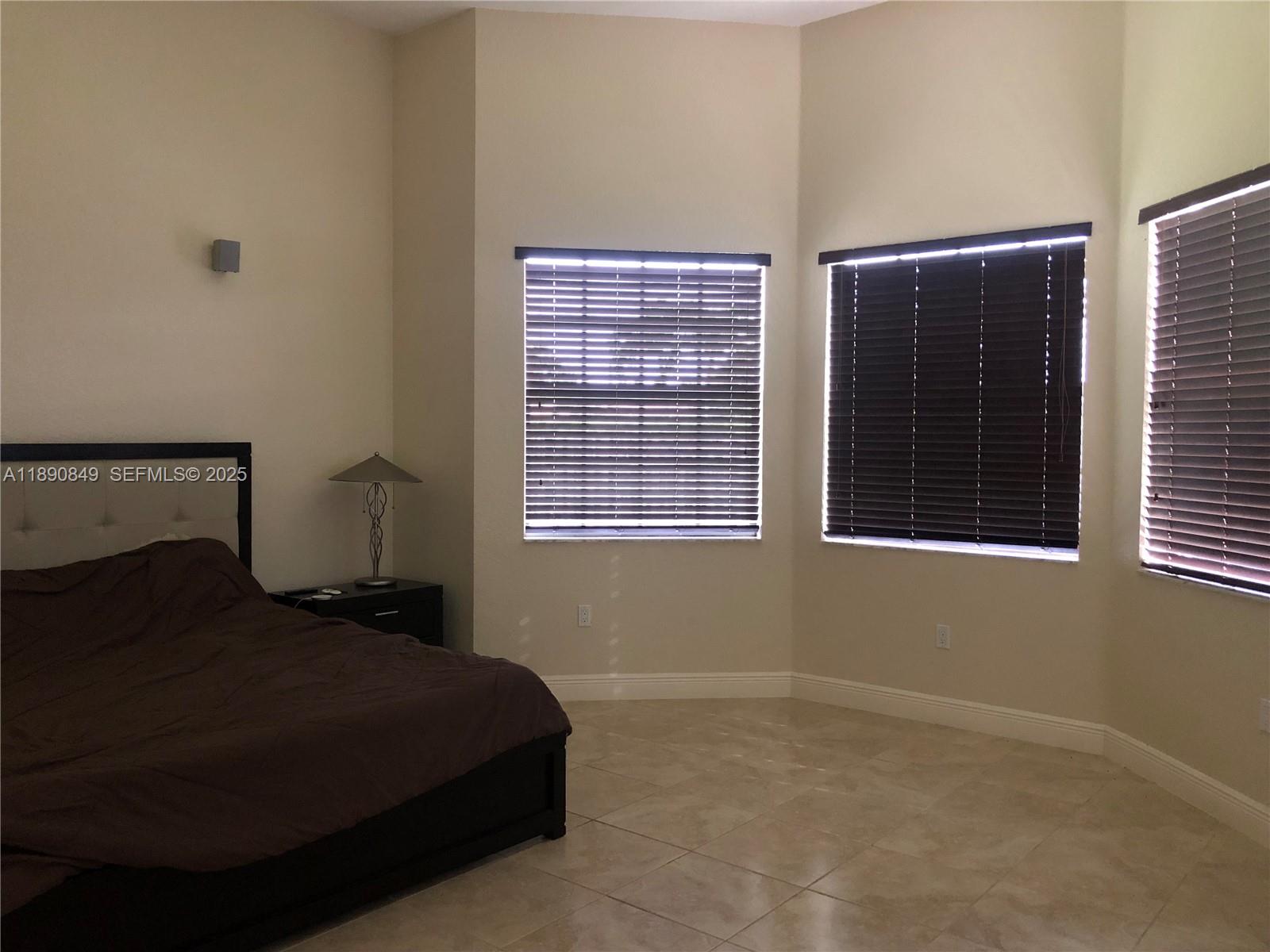 18721 Southwest 291st Terrace Homestead, FL 33030 - Photo 13 of 15 a bedroom with a bed and window