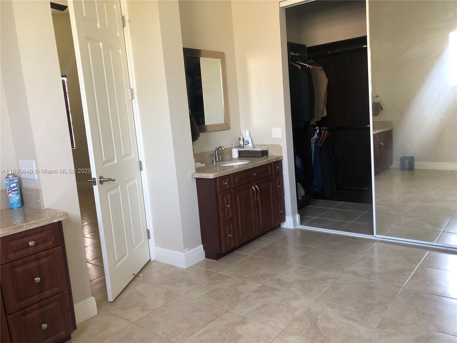 18721 Southwest 291st Terrace Homestead, FL 33030 - Photo 15 of 15 a bathroom with a double vanity sink and mirror