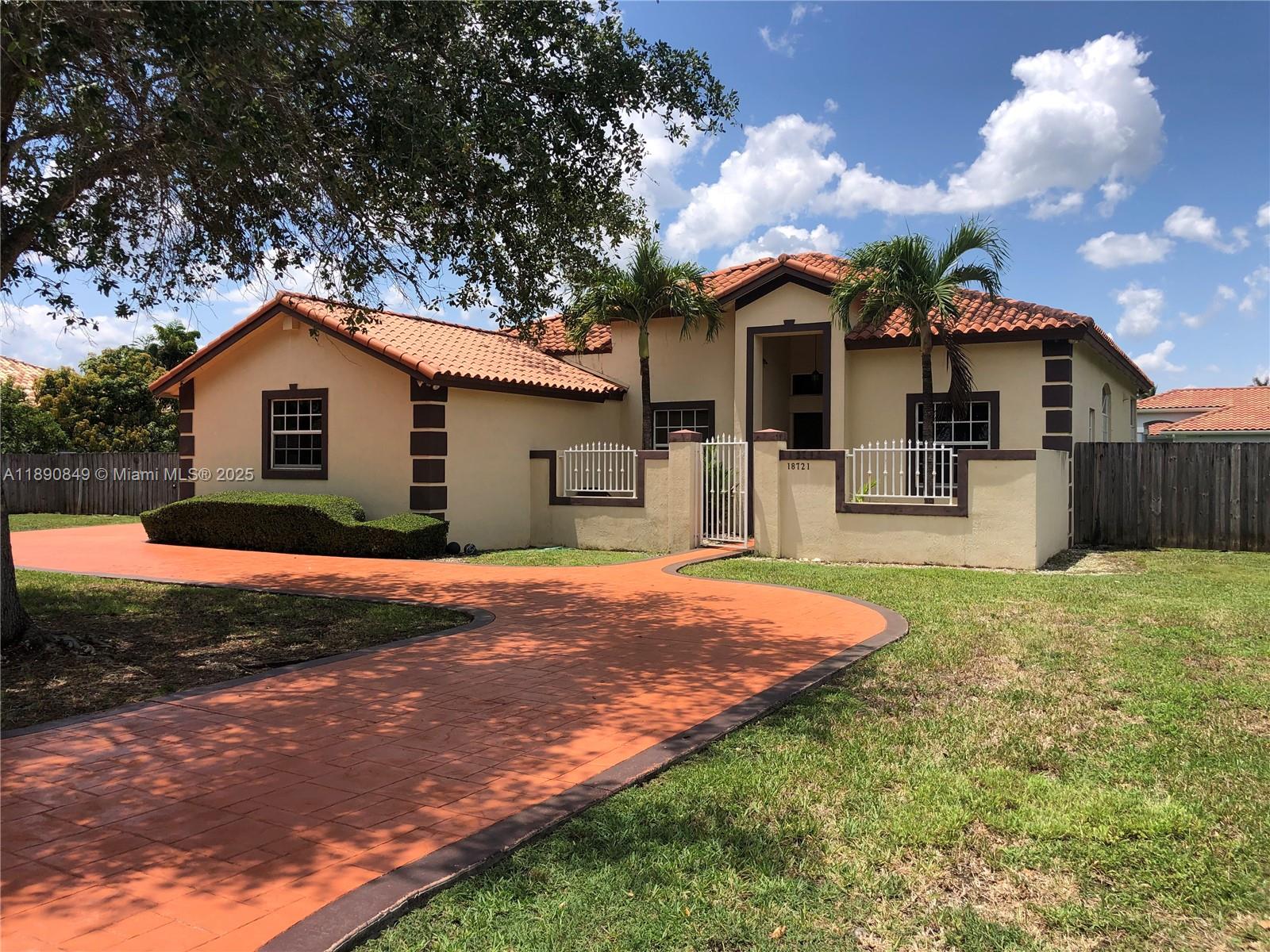 18721 Southwest 291st Terrace Homestead, FL 33030 - Photo 3 of 15 a front view of a house with a yard and garage