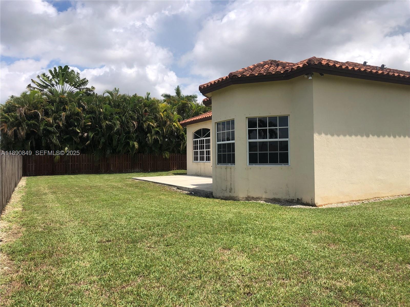 18721 Southwest 291st Terrace Homestead, FL 33030 - Photo 6 of 15 a view of a house with a yard and a garden