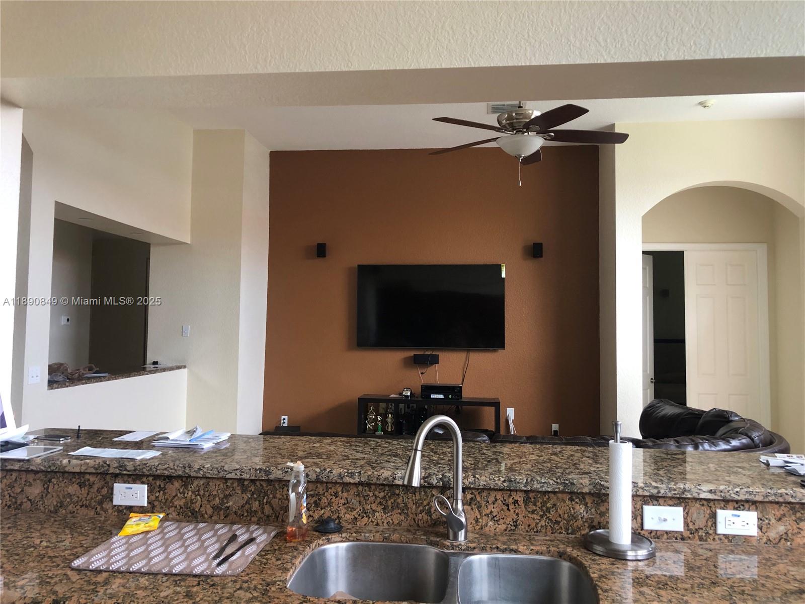 18721 Southwest 291st Terrace Homestead, FL 33030 - Photo 8 of 15 a kitchen with a sink granite counter tops and a view of living room