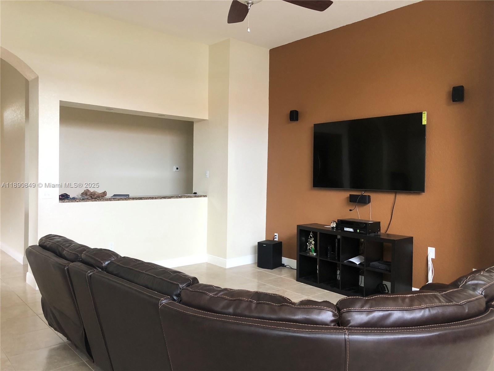 18721 Southwest 291st Terrace Homestead, FL 33030 - Photo 10 of 15 a living room with furniture and a flat screen tv