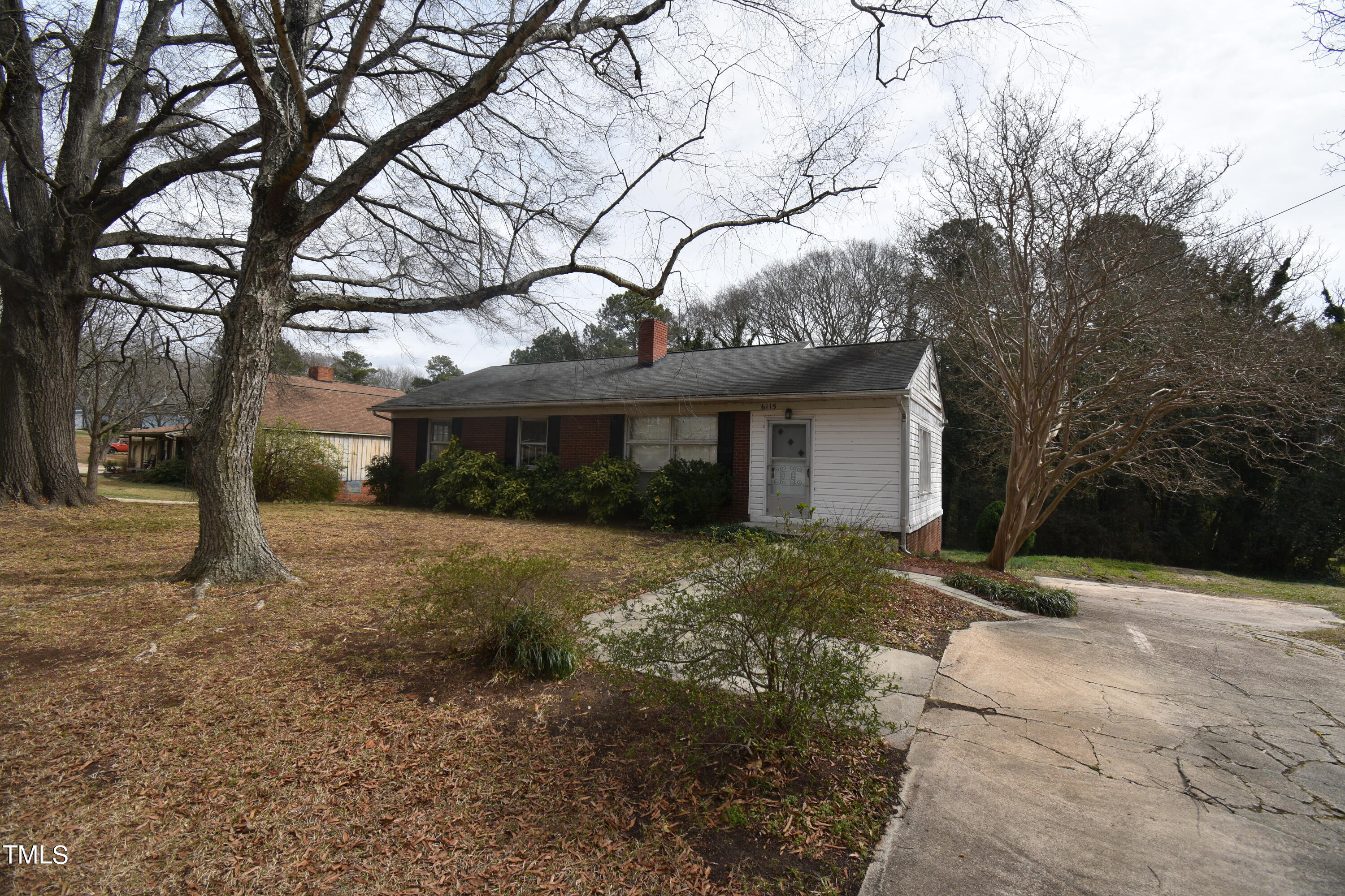 6115 Lake Wheeler Road Raleigh, NC 27603 - Photo 2 of 22 a view of a house with a yard and garage