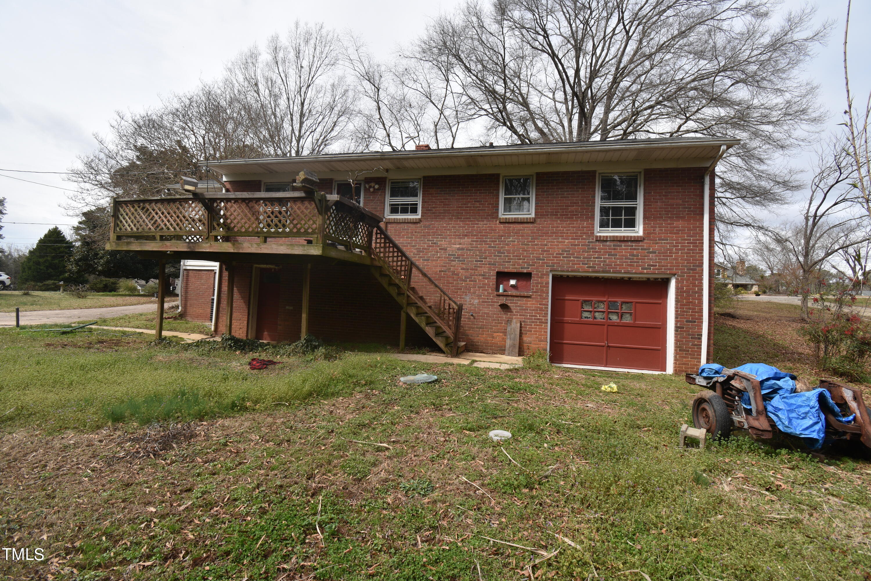 6115 Lake Wheeler Road Raleigh, NC 27603 - Photo 22 of 22 a view of a house with a yard fire pit and a large tree