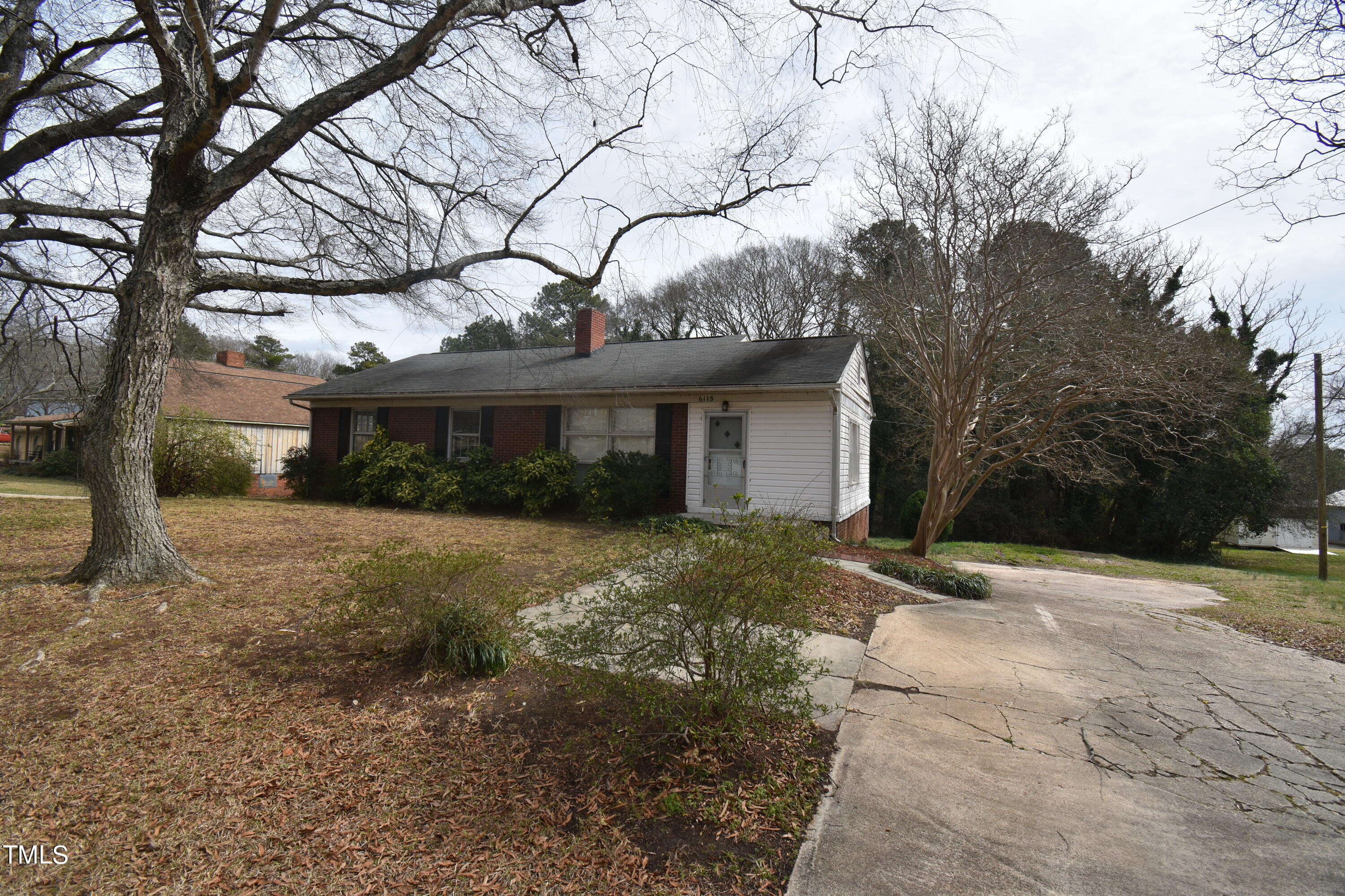 6115 Lake Wheeler Road Raleigh, NC 27603 - Photo 3 of 22 a view of a house with a yard and garage