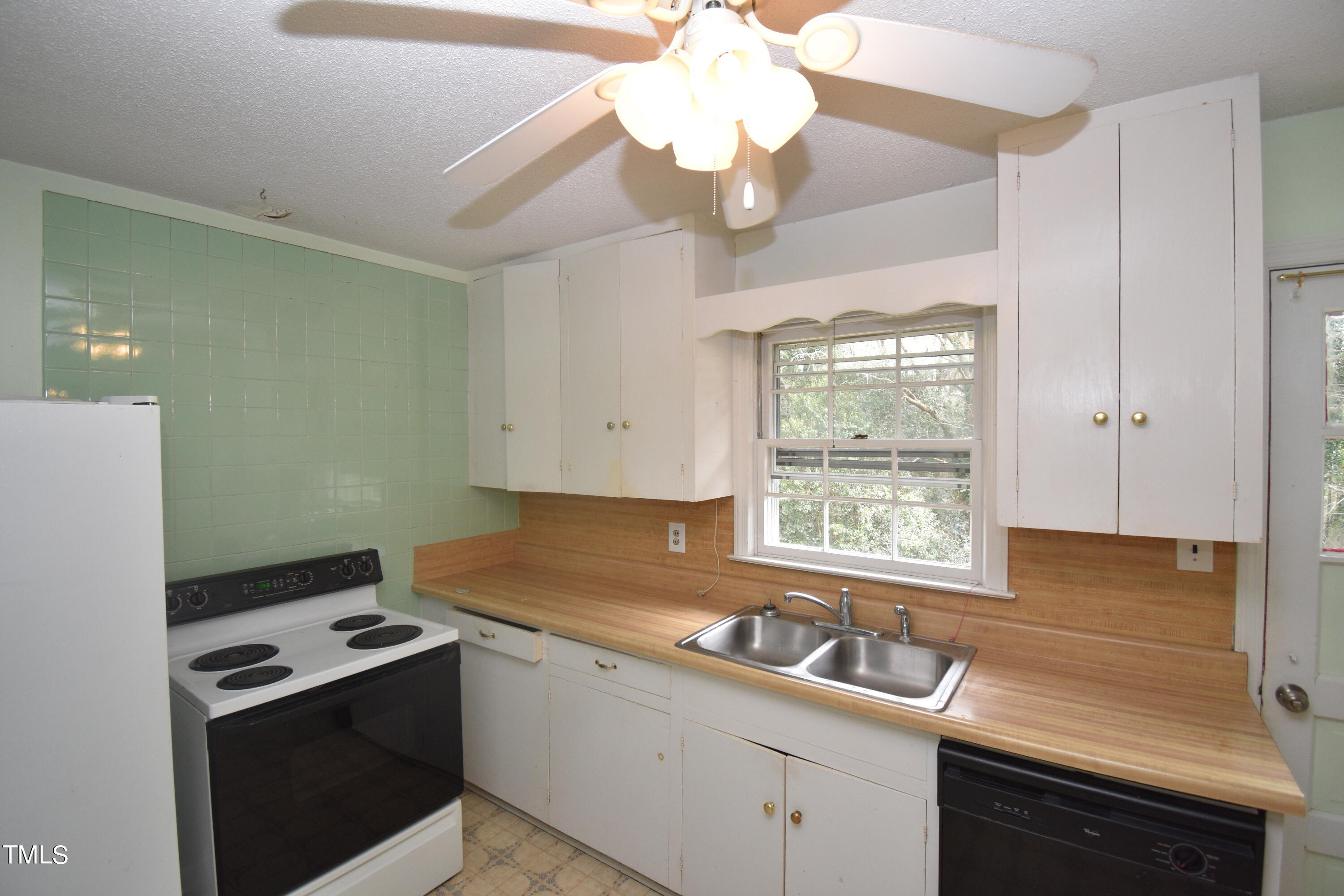6115 Lake Wheeler Road Raleigh, NC 27603 - Photo 9 of 22 a kitchen that has a sink a stove and a window