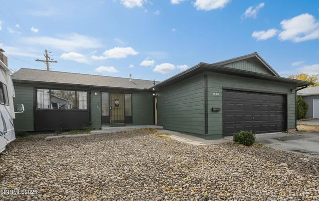 a view of a house with a yard and garage