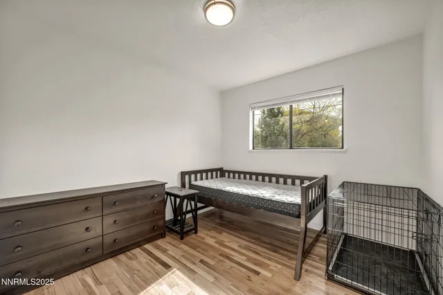 a view of a room with furniture and wooden floor