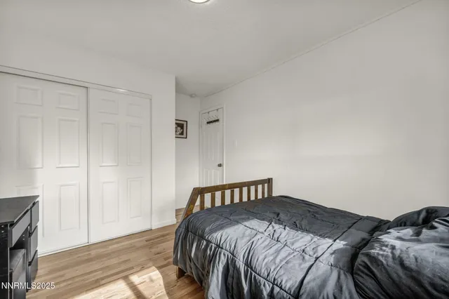 a bed sitting in a bedroom next to a window